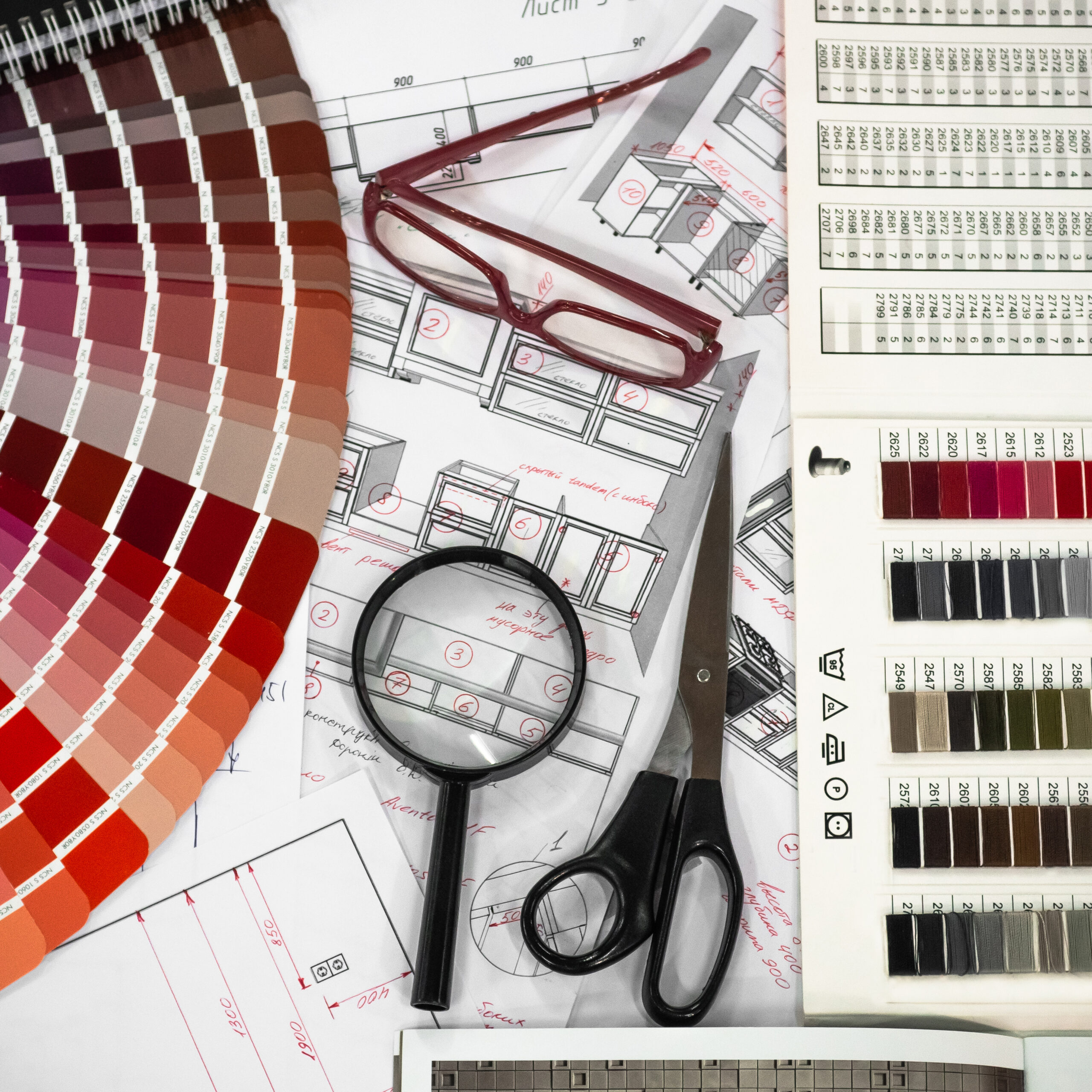 Architectural blueprint interior with wooden and paper samples and a multi-colored palette and draw tools
