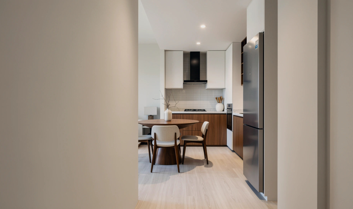 Open-plan kitchen and dining area with modern furniture and cabinetry