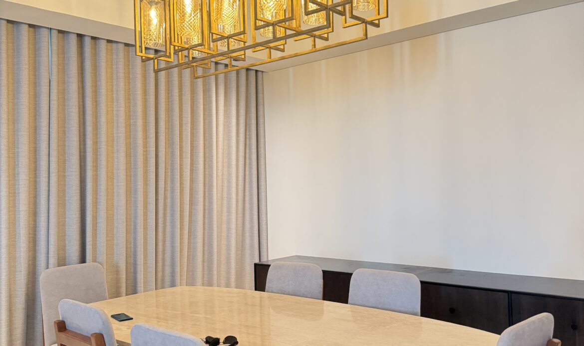 Dining room featuring a wooden table, chairs, and decorative chandelier