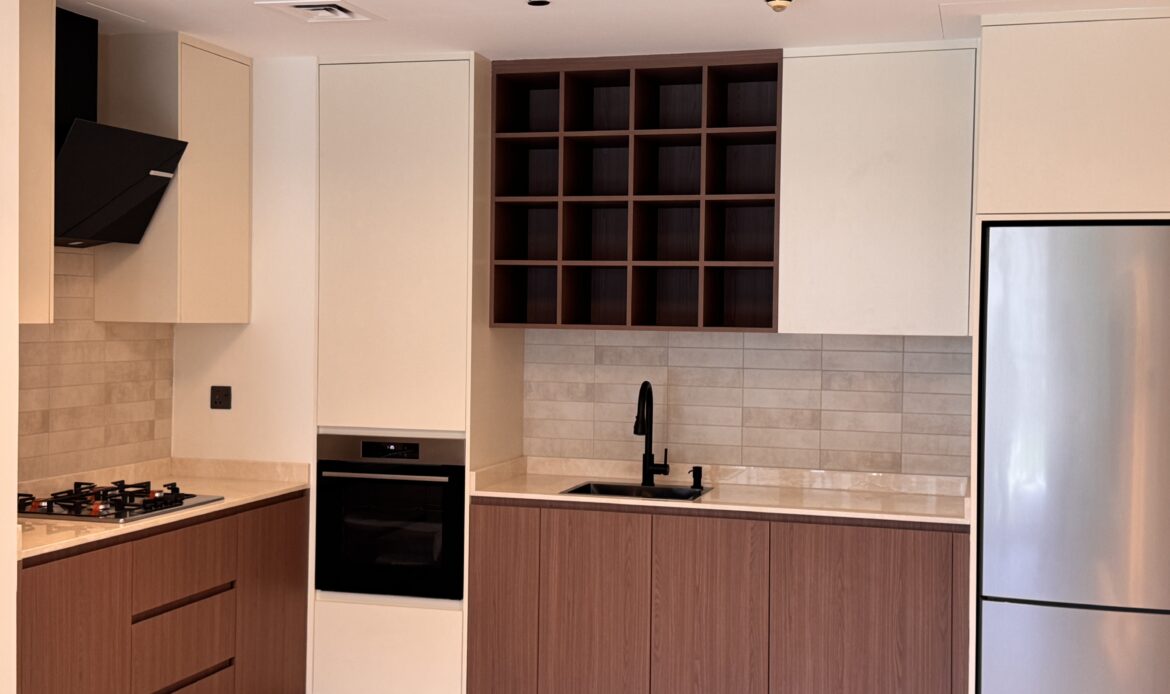 Open kitchen and dining area with dining table and contemporary cabinetry